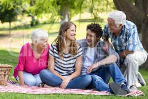 Smiling family sitting on a blanket
