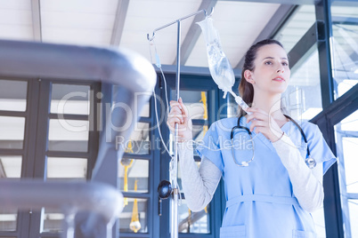 Doctor holding intravenous drip