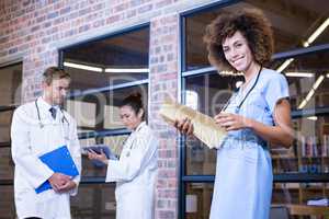 Female doctor checking a file near library