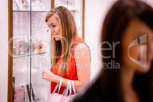 Woman looking at wrist watches in display