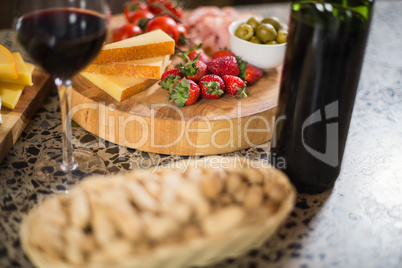 Wine bottle with a glass and a buch of food