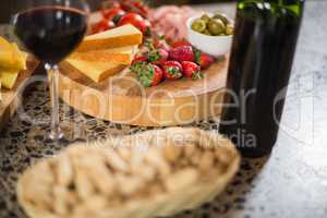 Wine bottle with a glass and a buch of food