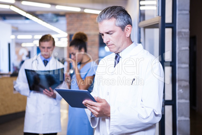 Doctor using digital tablet in hospital