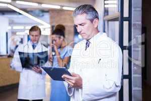 Doctor using digital tablet in hospital