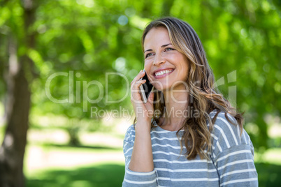 Smiling woman making a phone call