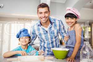 Portrait of happy man with children preparing food