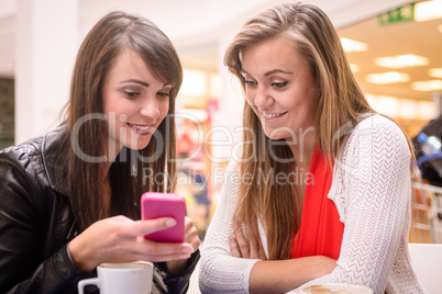 Two women looking at mobile phone