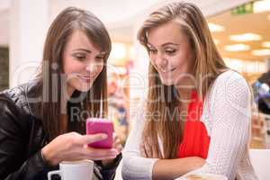 Two women looking at mobile phone