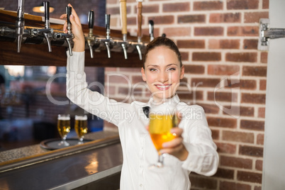 Barmaid holding a beer