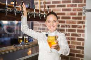 Barmaid holding a beer