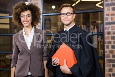 Businesswoman standing with lawyer near library