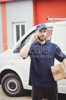 Delivery man making a phone call