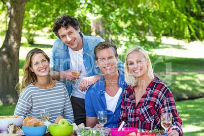 Friends having a picnic with wine