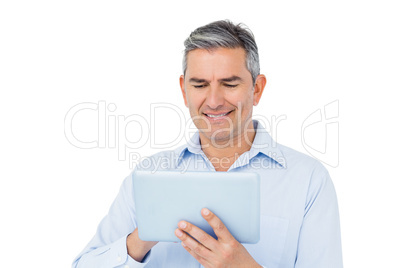 Smiling businessman using tablet