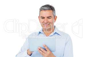 Smiling businessman using tablet