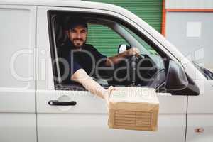 Delivery man sitting in his van