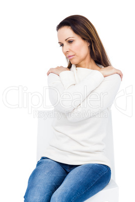 Desperate woman crossing arms on shoulders on white background