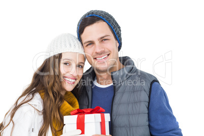 Happy couple holding gift box together