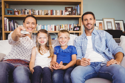 Smiling family watching television