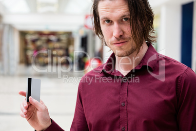 Portrait of man showing his credit card