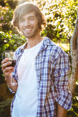 Smiling man with a glass of red wine