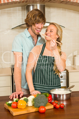 Pretty blonde making her boyfriend taste the preparation