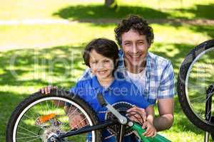 Father and son fixing the bike