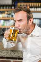 Handsome man drinking beer