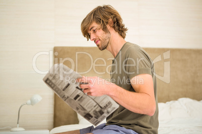 Handsome man reading a newspaper