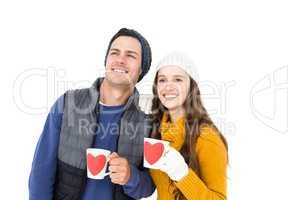 Smiling couple holding mug and looking away