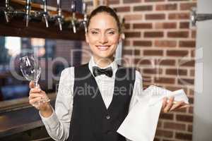Barmaid holding a wine glass and towel