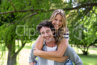 Husband giving a piggy-back to his wife