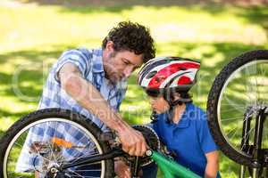 Father and son fixing the bike