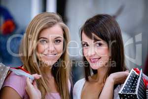 Portrait of two beautiful women shopping in mall