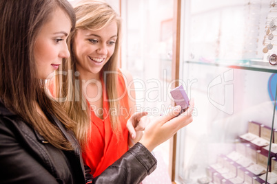 Two beautiful women selecting a finger ring