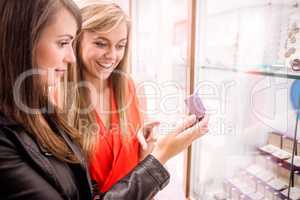 Two beautiful women selecting a finger ring