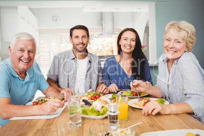 Portrait of family sitting at dining table