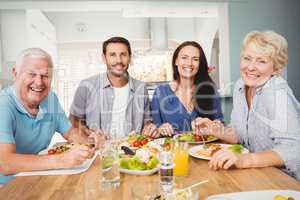 Portrait of family sitting at dining table