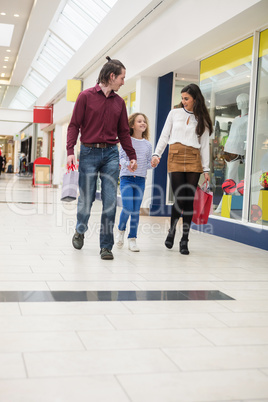 Happy family walking with shopping bags