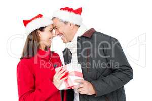 Festive couple exchanging christmas gift