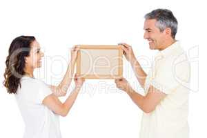 Happy couple holding picture frame
