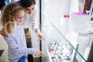 Mother and daughter selecting a wrist watch from shop display