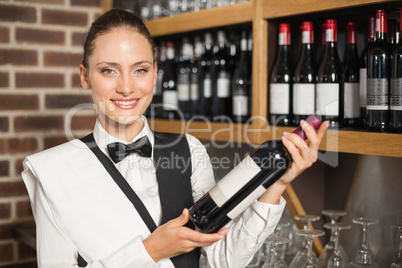 Barmaid holding a wine bottle