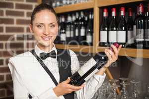 Barmaid holding a wine bottle