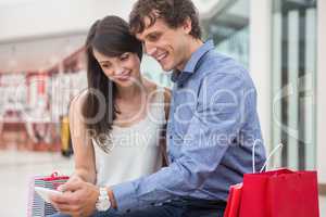 Happy couple looking at mobile phone