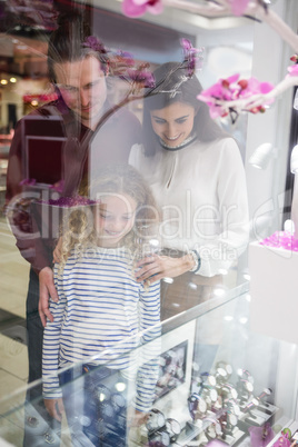 Happy family window shopping in mall