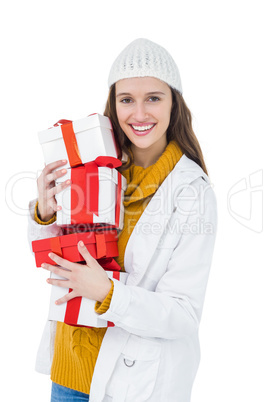 Pretty brunette holding several gifts