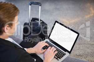 Businessman sitting on sofa and using laptop