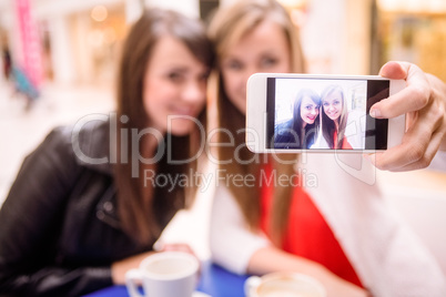 Women taking a selfie while having coffee