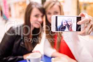 Women taking a selfie while having coffee